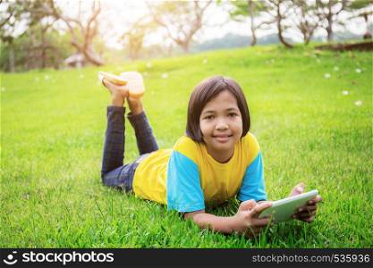Asian girls are happy on lawn in the park.