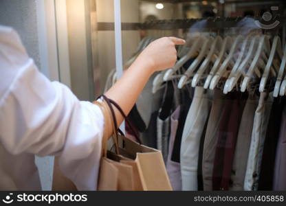 Asian girls holding sale shopping bags. consumerism lifestyle concept in the shopping mall