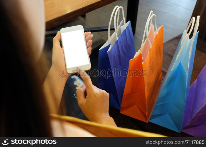 Asian girls holding sale shopping bags. consumerism lifestyle concept in the shopping mall