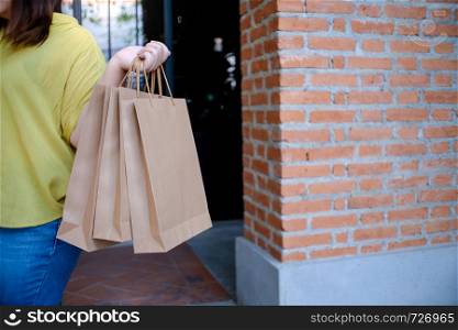 Asian girls holding sale shopping bags. consumerism lifestyle concept in the shopping mall