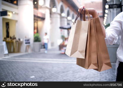 Asian girls holding sale shopping bags. consumerism lifestyle concept in the shopping mall