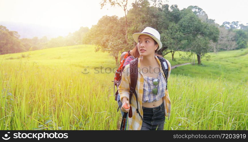 Asian Group of young people Hiking with friends backpacks walking together and looking map and taking photo camera by the road and looking happy ,Relax time on holiday concept travel