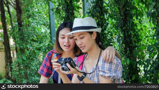 Asian Group of young people with friends backpacks walking together and happy friends are taking photo and selfie Relax time on holiday concept travel