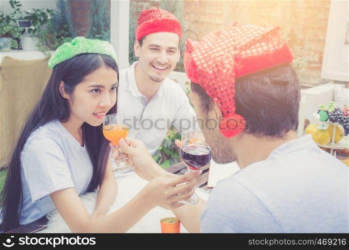 Asian group people man and woman drink and celebration at party outdoor. group of friends social event with beverage on hand with achievement, festive concept.