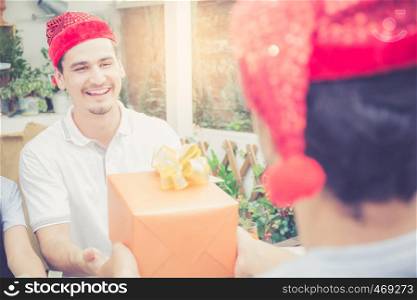 Asian group people man and woman giving gift box and celebration at party outdoor. group of friends social event with birthday achievement, festive concept.