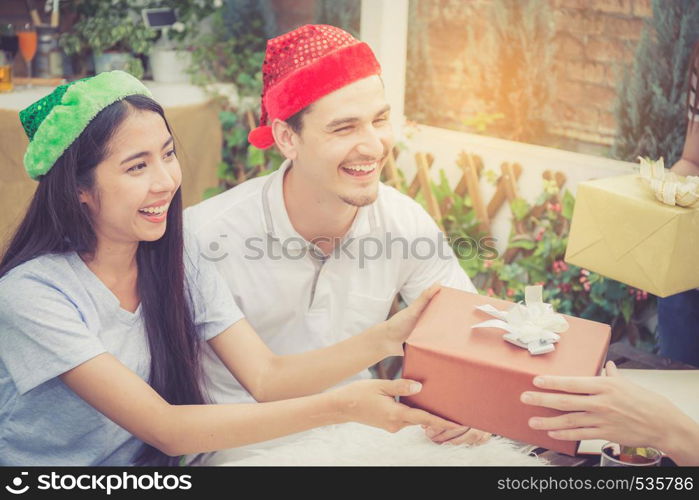 Asian group people man and woman giving gift box and celebration at party outdoor. group of friends social event with birthday achievement, festive concept.