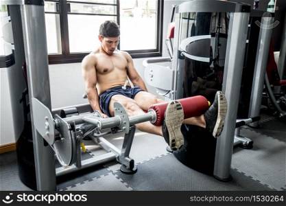 Asian handsome Man workout with Leg Extensions for builder muscle in upper leg exercise in gym feeling so strong and powerful,Bodybuilder Concept