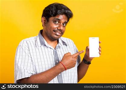 Asian happy portrait young black man smile standing wear shirt making finger pointing on smart digital mobile phone blank screen isolated, studio shot yellow background with copy space