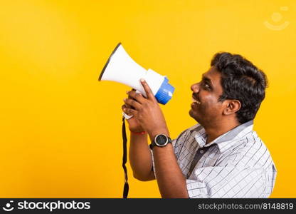 Asian happy portrait young black woman standing to make announcement message shouting screaming in megaphone, studio shot isolated on yellow background with copy space