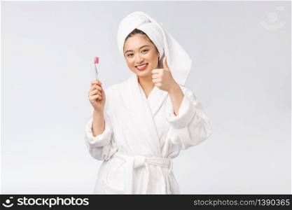 Asian happy woman with toothbrush in bathrobe morning mood.. Asian happy woman with toothbrush in bathrobe morning mood