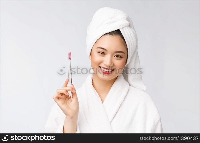 Asian happy woman with toothbrush in bathrobe morning mood.. Asian happy woman with toothbrush in bathrobe morning mood