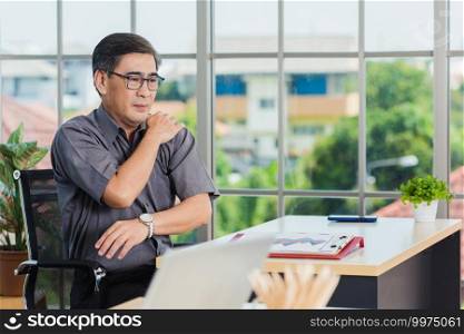 Asian hard senior businessman working with laptop computer has a problem with shoulder pain. Old man feeling pain after sitting at desk long time, Healthcare and medicine office syndrome concept