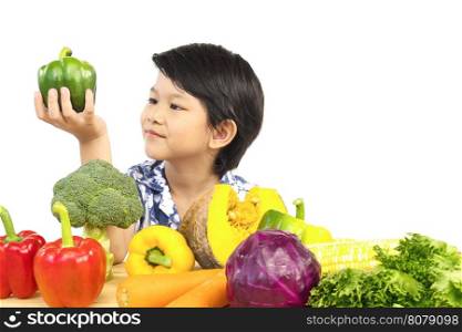 Asian healthy boy showing happy expression with variety fresh colorful vegetable over white background
