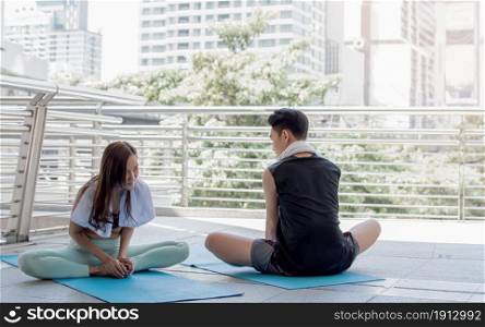 Asian healthy couple doing exercise, yoga and stretch outside. Sport and Lifestyle Concept.
