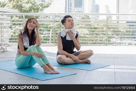 Asian healthy woman doing exercise and stretch outside. Sport and Lifestyle Concept.