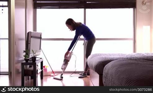 Asian housemaid cleaning hotel room, young woman job, people working. Chinese girl in resort, staff at work as maid, professional occupation. Housekeeper wiping floor with vacuum cleaner at home