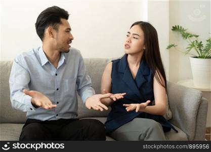 Asian husband explained the mental health problems that occurred to his wife while sitting on the couch at home, Health and illness concepts.