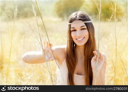 Asian indian woman portrait in golden dried grass field