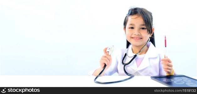 Asian kid as doctor and health care concept. Wellness and Self-care. Children dream job when grow up for help people to stop Coronavirus.