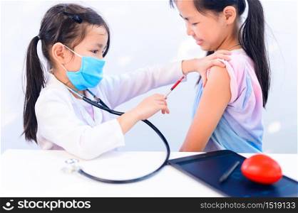 Asian kid as doctor and health care concept. Wellness and Self-care. Children dream job when grow up for help people to stop Coronavirus.