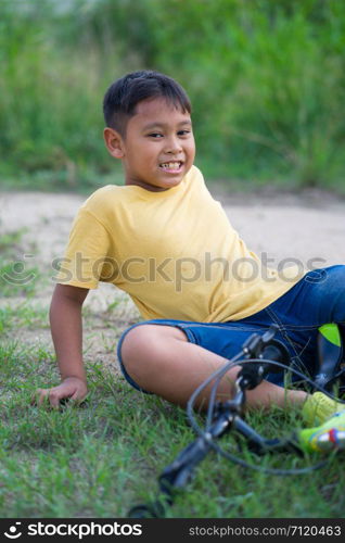 asian kid boy have accident when ride bicycle