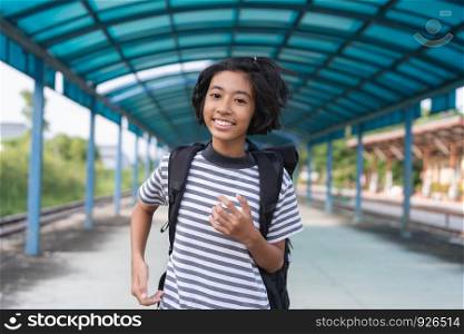Asian kid girl is walking to school while carrying a backpack, Back to school concept