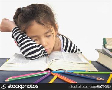 Asian kid is sleeping while reading a big book