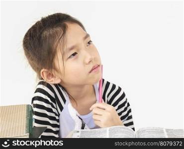 Asian kid is thinking while reading book