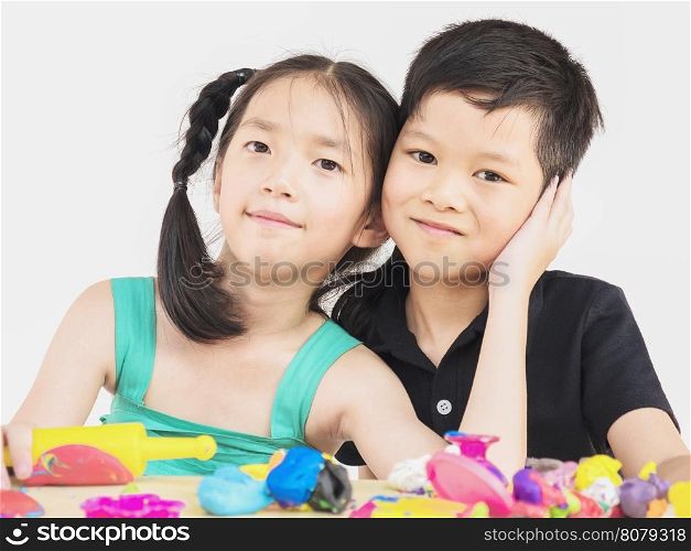Asian kids are playing colorful clay toy