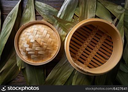 Asian kitchen bamboo steamer for steam cooking recipes on leafs