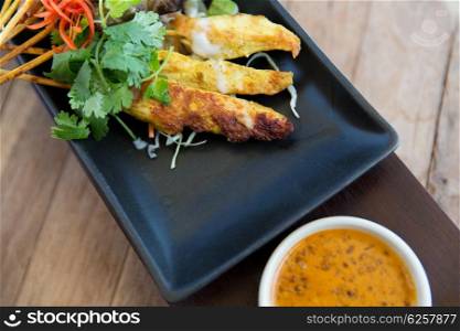 asian kitchen, food, culinary and cooking concept - close up of deep-fried snacks on plate at restaurant
