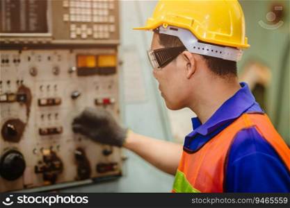 Asian labor worker hard working with control safety machine in metal factory industry.