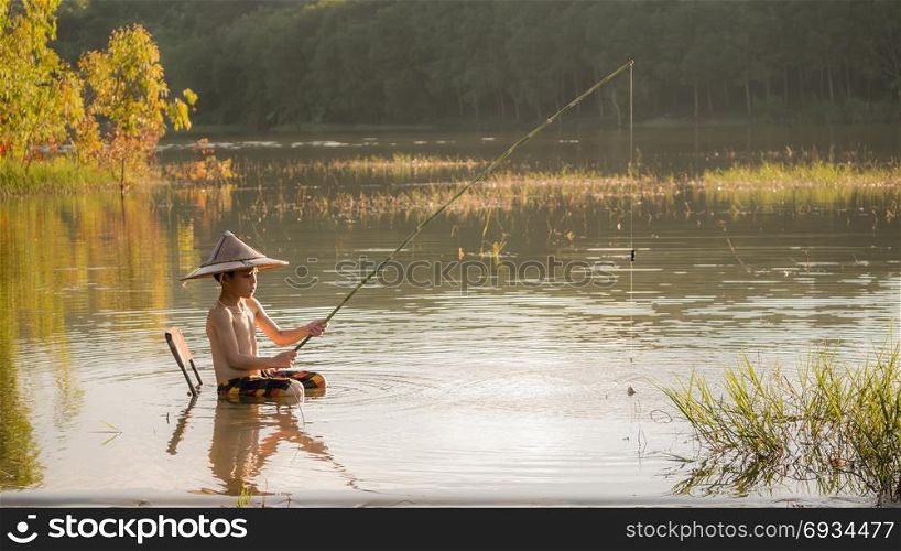 asian little boy fishing. asian little boy fishing in a lake
