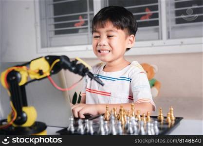 Asian little boy programming code to robot machine arm on laptop for play chess, STEM education E-learning, Funny children learning getting lesson control robot arm, Technology science education