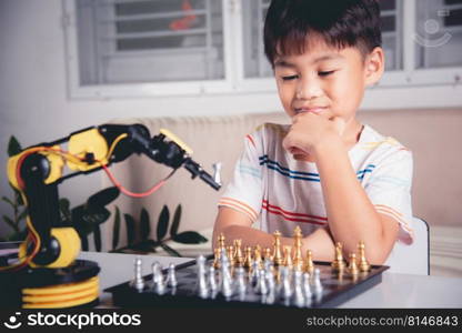 Asian little boy thinking and wait robot arm playing chess, STEM education E-learning, Funny children learning successful getting a lesson control robot arm game, Technology science education concept