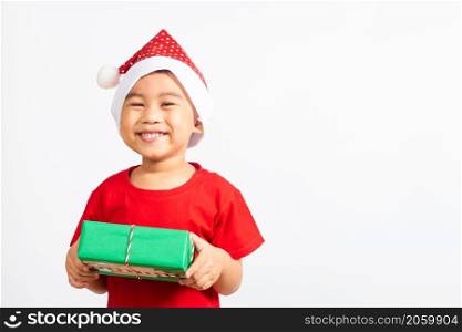 Asian little child cute boy smile and excited, Kid dressed in red Santa Claus hat hold gift box on hands concept of holiday Christmas Xmas day or Happy new year isolated on white background