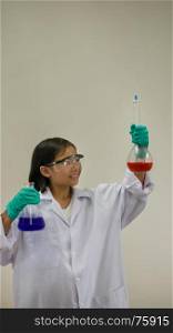 Asian little girl holding test tube. Asian little girl holding test tube or laboratory flask . Education concept.