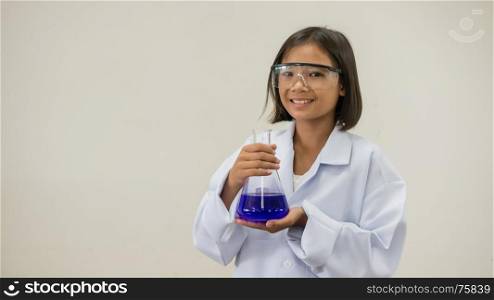 Asian little girl holding test tube or laboratory flask . Education concept.. girl holding test tube