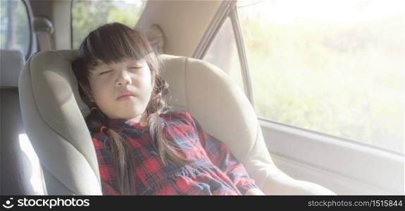 Asian little girl sleeping in car with car seat