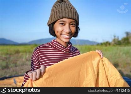Asian little girl smile and happy enjoying Nature at camping in the winter. The concept of family lifestyle on holiday