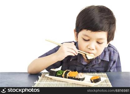 Asian lovely boy is eating sushi over white background