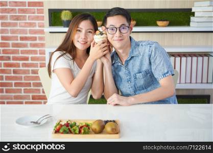 Asian lover couple made their meal together in apartment kitchen.Young couple Helping to make a weekend meal.