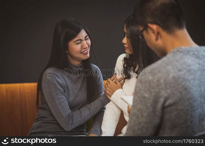 Asian male professional psychologist doctor giving the consult to lovers patients which have relationship problem in modern living room of house or hospital exam room, Mental health Concept