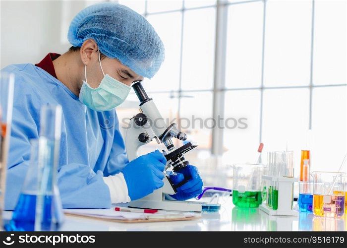 Asian male researcher in laboratory or chemist notes while studying virus s&le using microscope