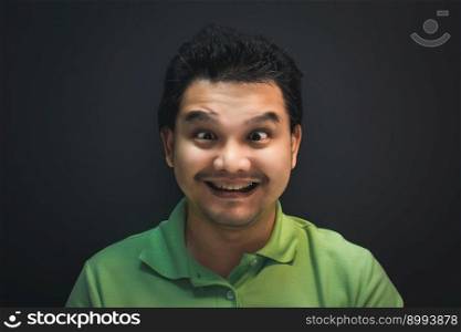Asian man 40s smile have a crazy squinting gesture with confusion and problems concept on black background dark style. Asian man smile have crazy squintin with confusion