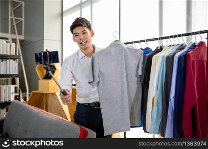 Asian man blogger broadcasting a video for selling product online .Shopping online concept