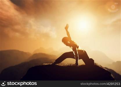 Asian man, fighter practices martial arts in high mountains at sunset. Kung fu and karate pose. Also concepts of discipline, concentration, meditaion etc. Unique