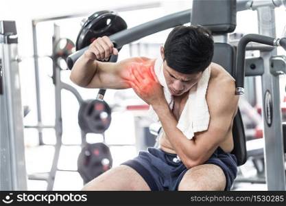 Asian man have injury muscle joint between shoulder and arm pain after workout in gym,Healthcare concept
