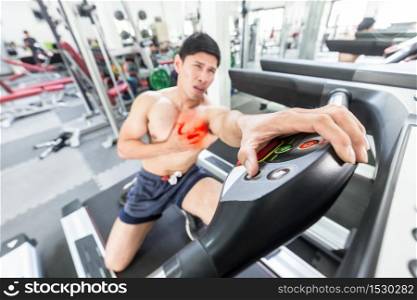 Asian man Heart attack after running workout on treadmill in gym,Healthcare and medical Concept