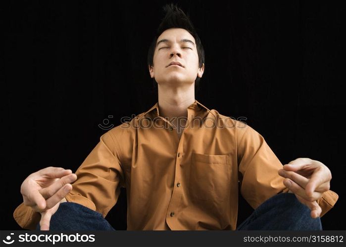 Asian man in yoga pose